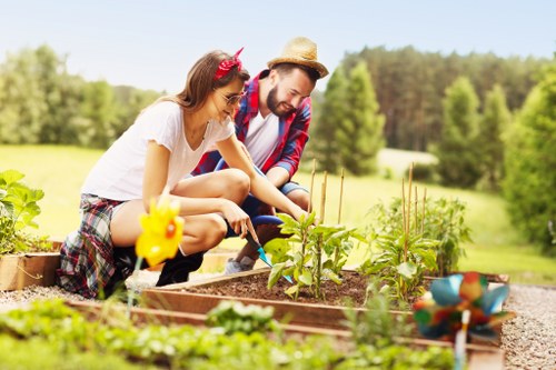 Landscape gardening in Park Royal with a neat patio and planting beds